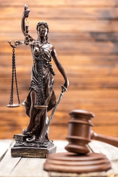 Statue of lady justice and mallet on wooden table, Law concept